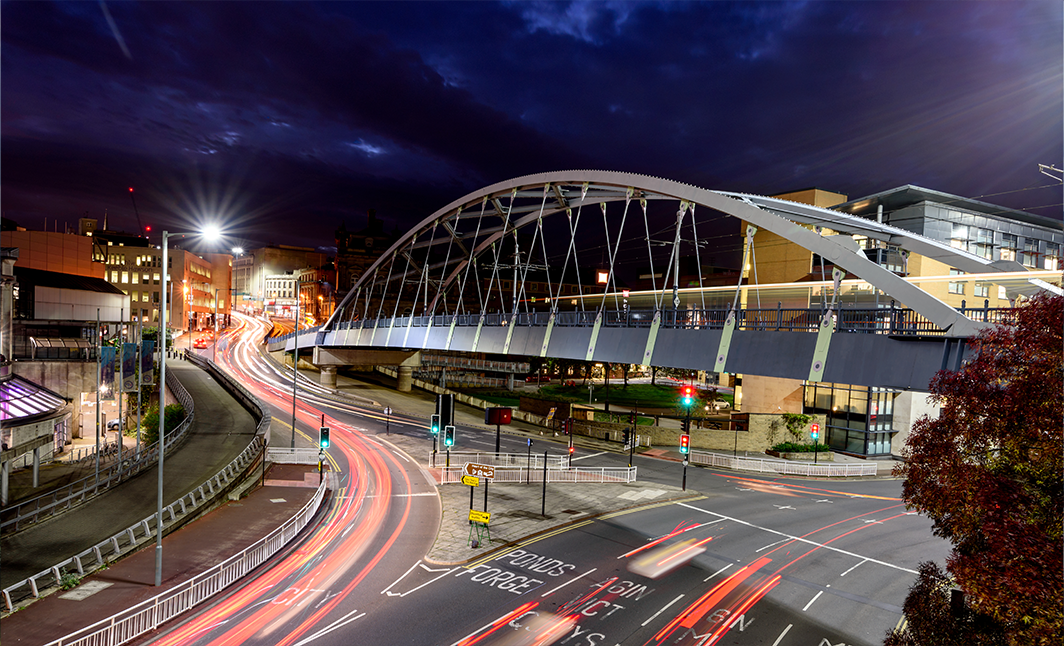 Long exposure image showing Sheffield with glowing lights.