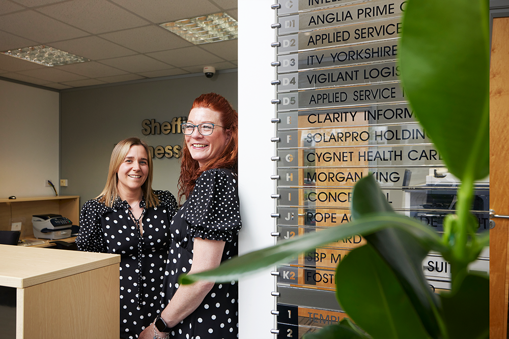 Two of the reception team at Sheffield Business Centre smiling.